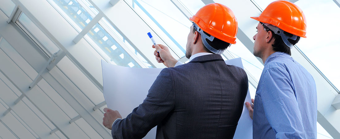 two men looking at construction plans